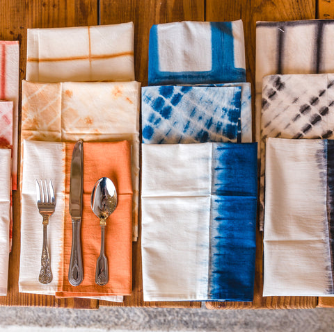 TerraKlay natural hand dyed dinner napkins in indigo, red, orange and black in different designs.