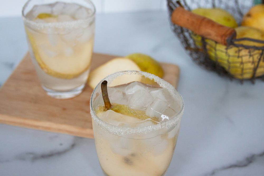 Pear gin fizz recipe garnished with fresh pears and made with Raven's Nest cinnamon pear jam