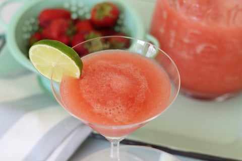 Strawberry jalapeno daiquiri garnished with a lime with fresh strawberries made with Raven's Nest jam