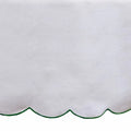 White cotton embroidered tablecloth with soft green scalloped detailing, blending natural charm and elegance for refreshing spring gatherings and cozy dinners alike.