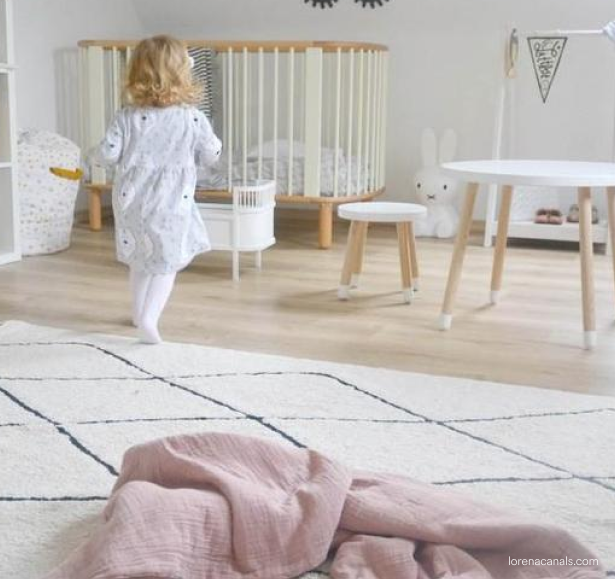 Image of toddler running on rug 