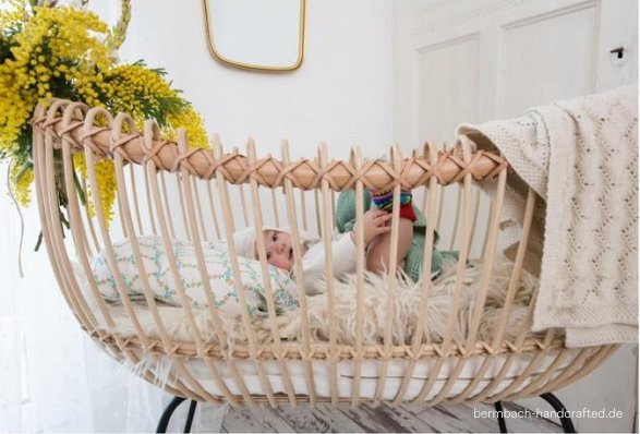 baby in a rattan crib 
