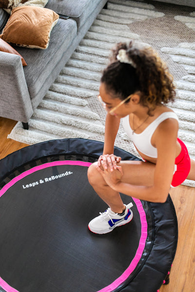 lady stepping on rebounder to exercise