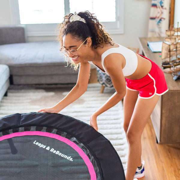 woman pulling out her rebounder for a workout