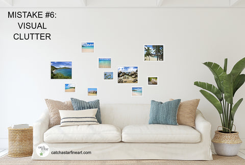A tropical themed room with a couch and palm tree.  On the wall are beach photos in different sizes in a haphazard arrangement that looks sloppy.