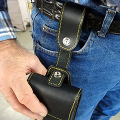 Holster style phone case showing case being attached to belt strap