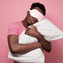 Man with eye mask and pillow