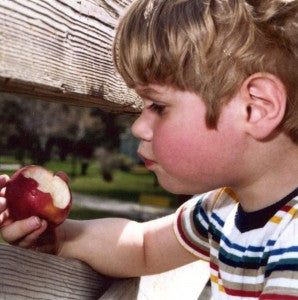 The author as a boy, considering the mysteries of the apple.
