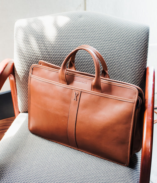 brown briefcase on chair