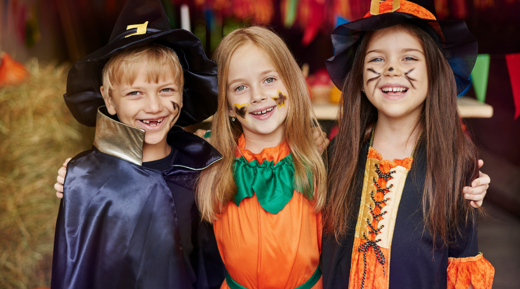 Three kids wearing costumes