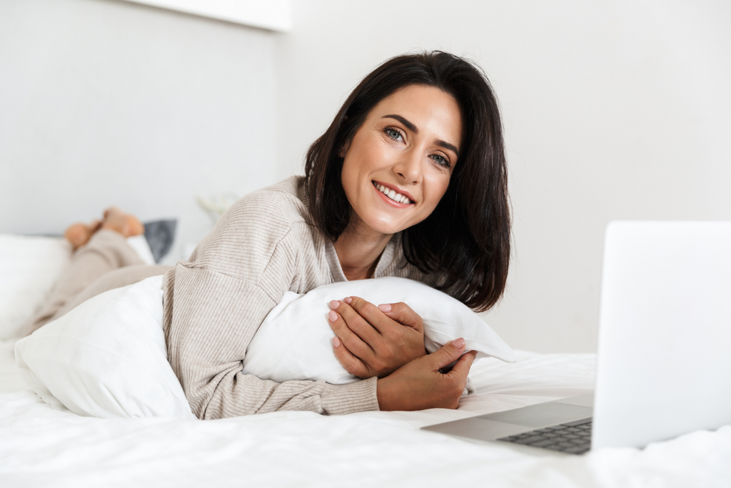 Woman in bed with laptop
