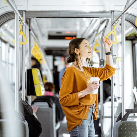 Woman standing in a bus