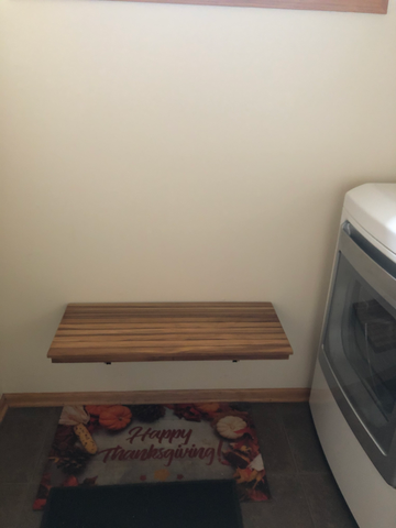 Wall Mounted Folding bench placed in laundry/mudroom to be used for extra folding space, or to put on and take off shoes.