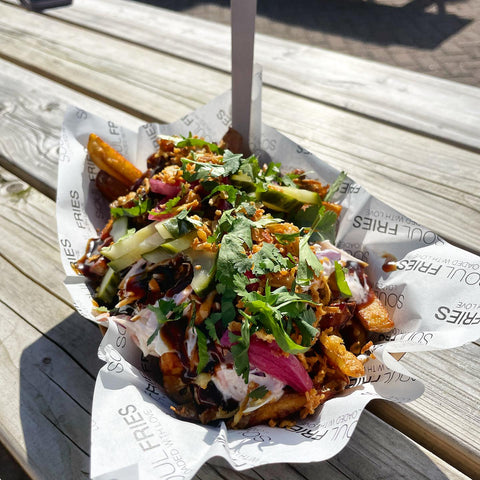 Loaded fries served in branded greaseproof paper