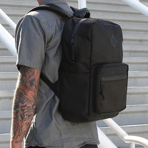 Man wearing a smell proof bag that is a backpack in downtown San Diego.