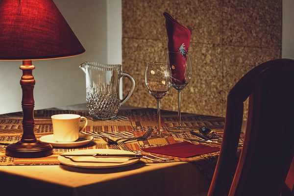Jack Dusty Clothing & Lifestyle Blog - Dinner Etiquette - Dinner table in a nice, dimly lit restaurant.