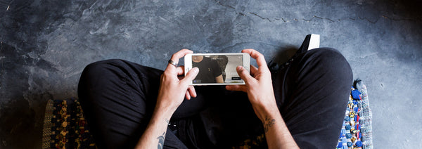 business man on phone visiting the Jack Dusty Clothing Page on facebook, wood floor.