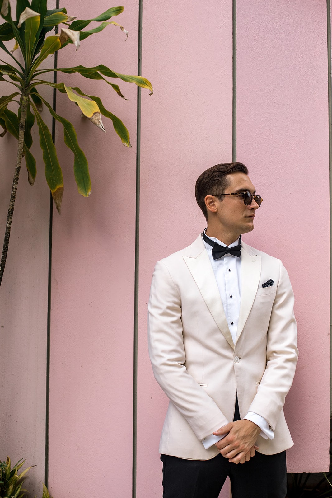 The groom against a pink background