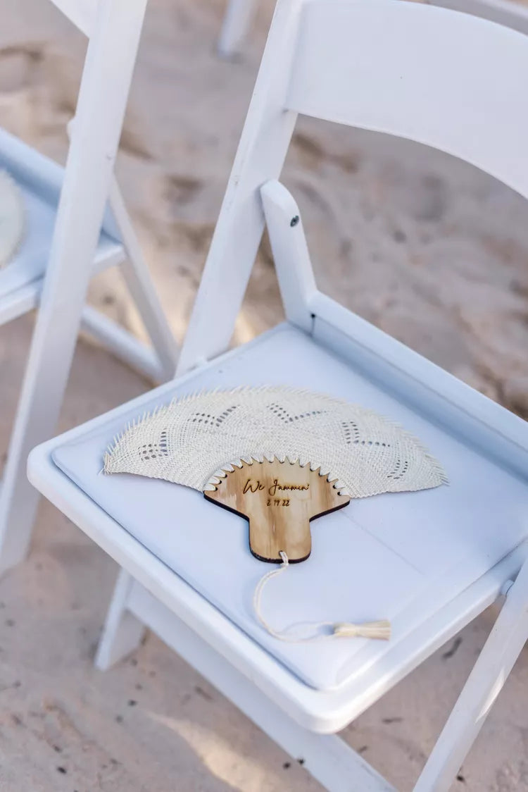 hand fan for wedding personalized on top of a white wooden chair