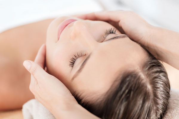 A woman receiving a facial at a Bluemercury Spa