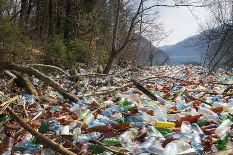 Plastic trash piled up in a river in the mountains