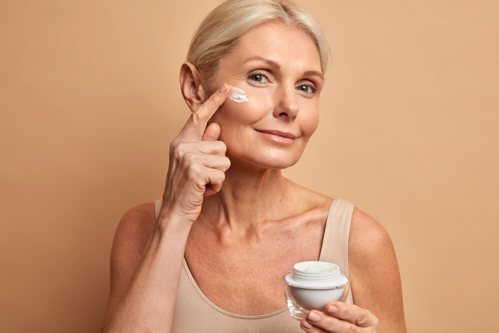Woman applying moisturizer to her face