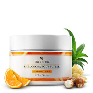 Moisture Defense Shea Body Butter surrounded with aloe vera, orange slices and shea butter, against a white background