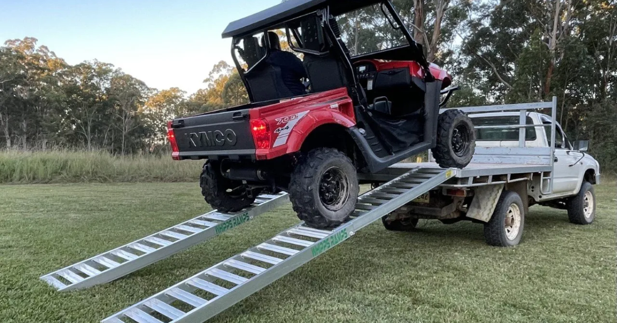 ATV loading up a trailer using a pair of aluminium ATV loading ramps