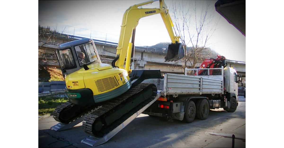 Photo of an excavator loading a ute on a pair pf Digga 6.2 Tonne Ezi-Loada Aluminium Loading Ramps