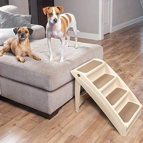 2 Dogs sitting on a bed with pet stair