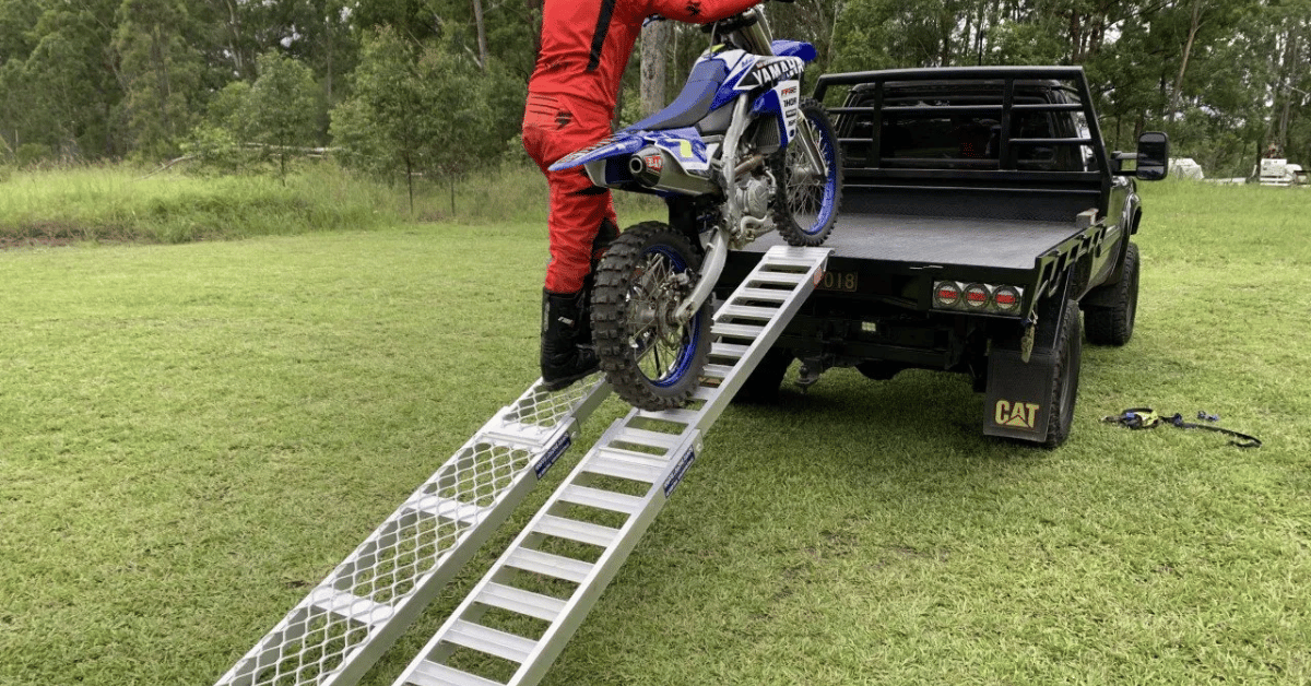 man loading a motorcycle using motorcycle loading ramps