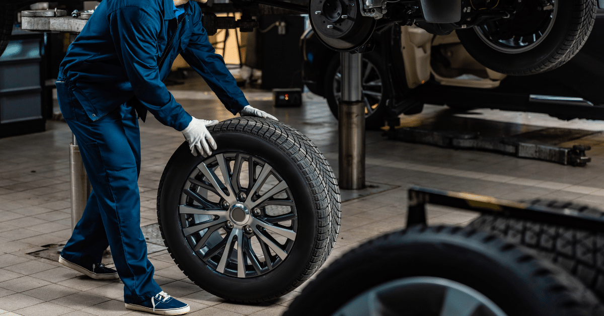 mechanic replacing a car's tyre