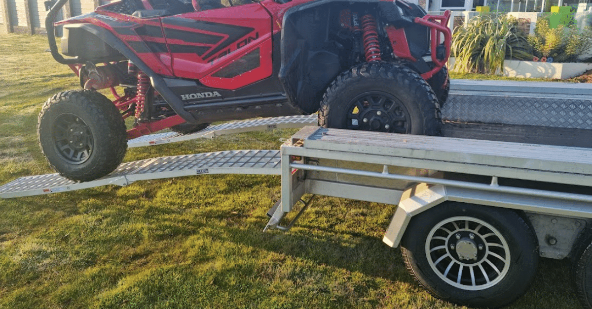 ATV loading a ute with a pair of loading ramps