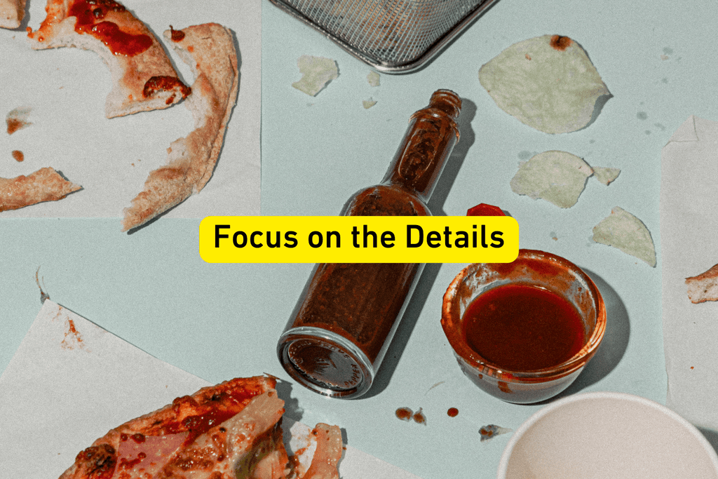 close up photo of a table top with eaten pizza slices and a brown bottle