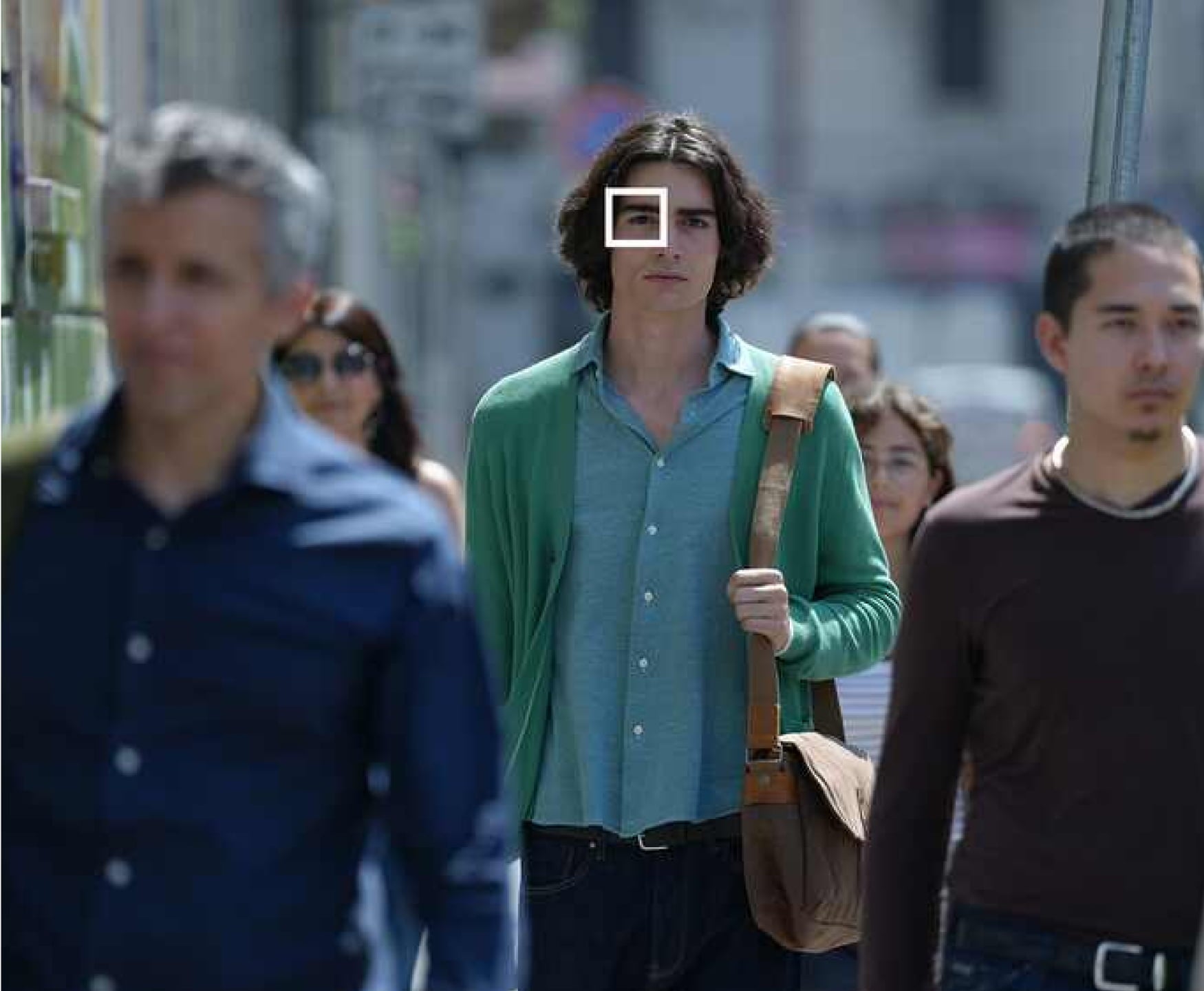 crowd of people walking in a city