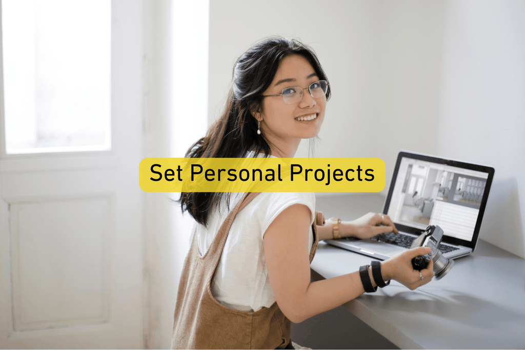 female photographer sitting by a laptop with Set Personal Projects text overlay