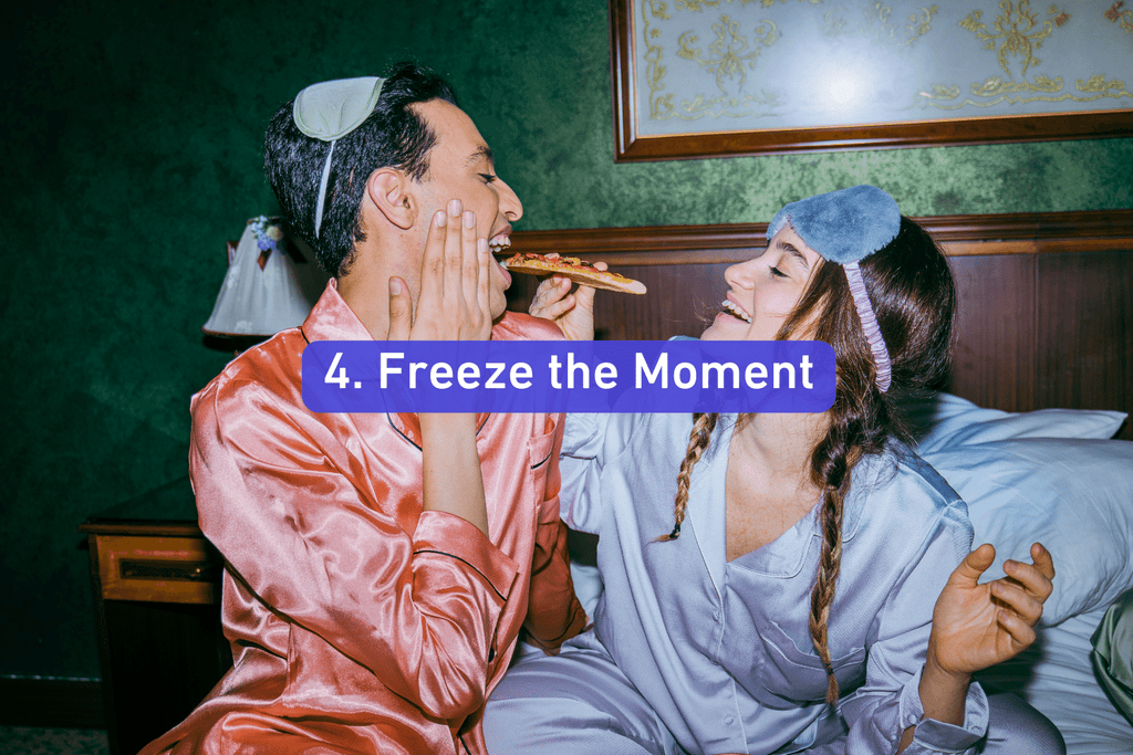 a young man and women in pajamas feeding each other pizza in bed