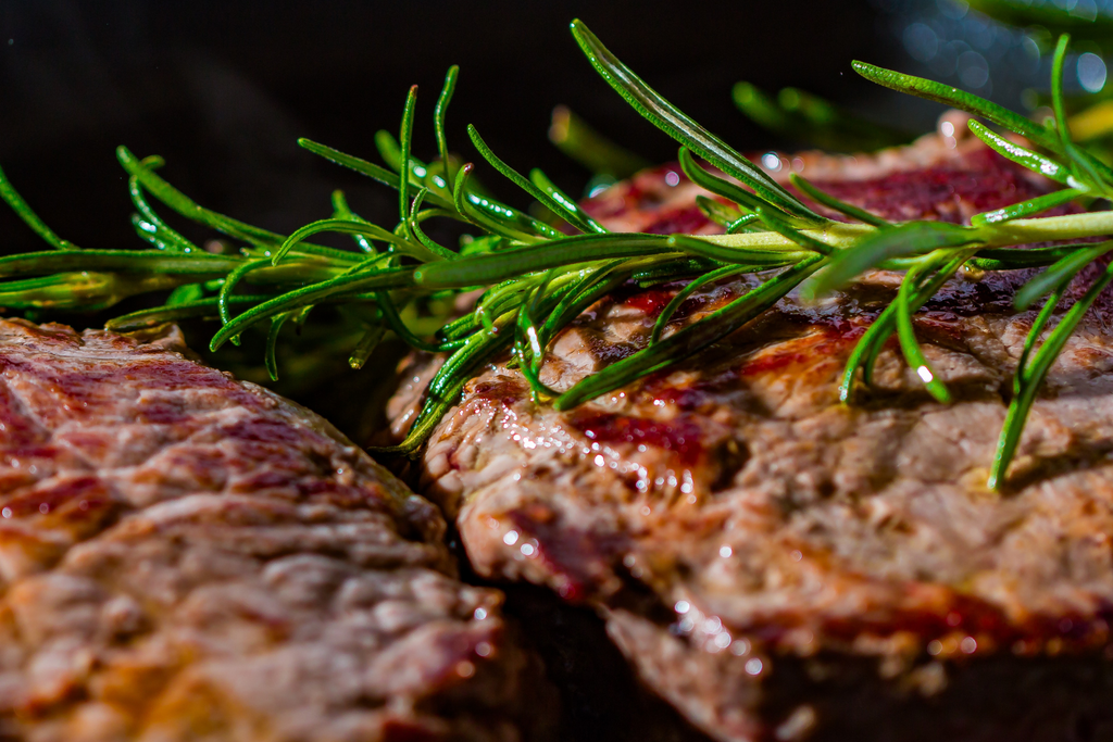 Close up photo of steak and rosemary