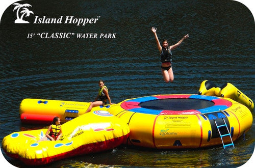 Island Hopper 15ft Classic Water Trampoline Park. 1 girl jumps while 2 other girls play on the attachments.