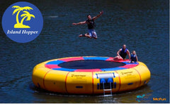 Island Hopper Acrobat 20ft Water Trampoline for Sale. One man jumps while 2 others sit on the lake trampoline.