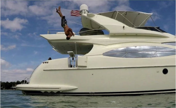 Lillipad Diving Board for Boats on a Sea Ray Cruiser. A young man does a backflip off the side of the boat.