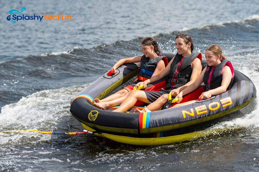 This is the HO Neo 3 with 3 people sitting on it, holding onto the handles while being dragged by a speedboat on the water.