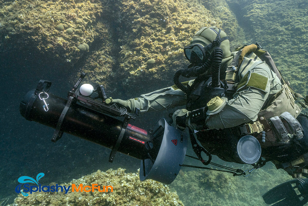 A man in a grey wetsuit uses this large and sleek water scooter to travel through the water.