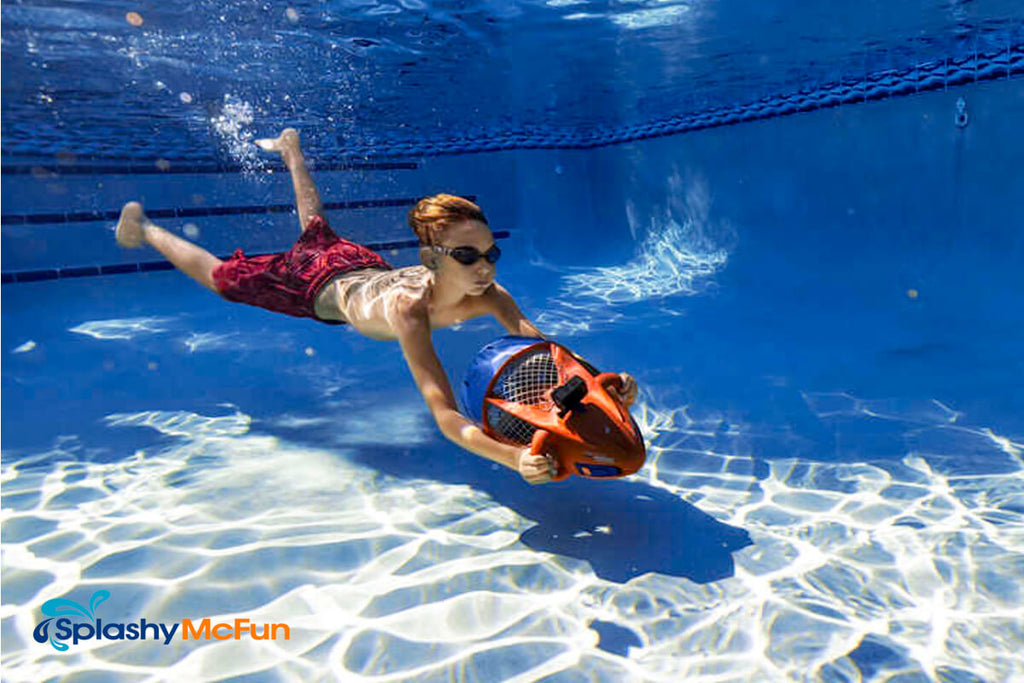 Boy uses and Nautica Skipper under water scooter to glide through the water.