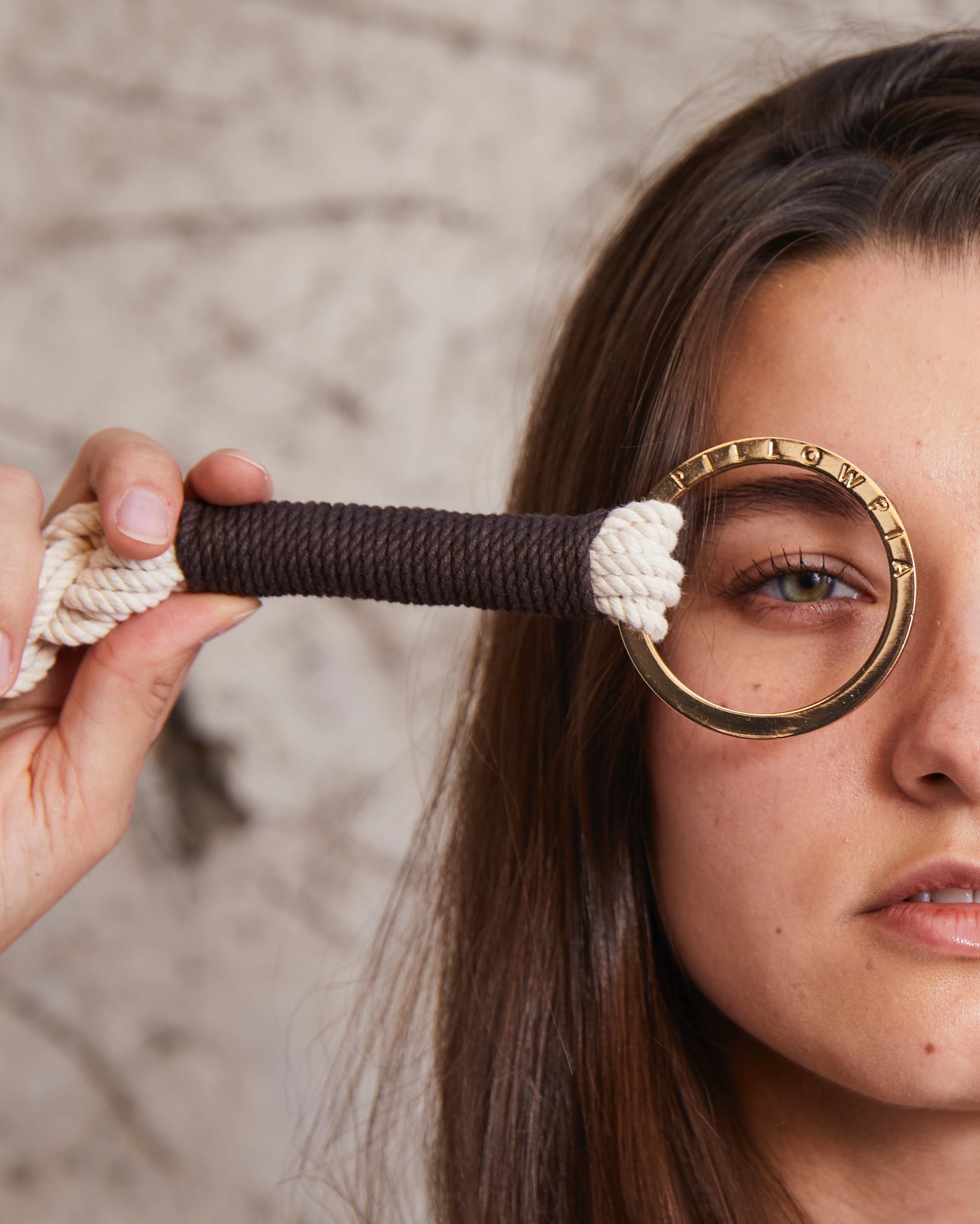 close up of woman with gold ring of a plant hanger around her eye