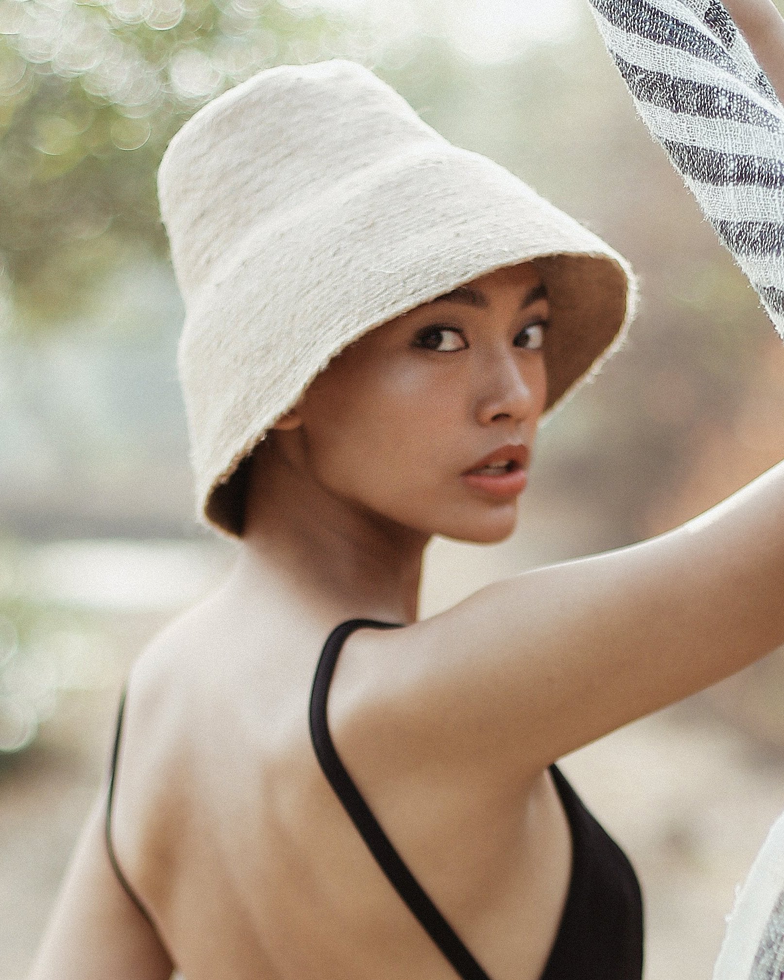 woman wearing jute hat on beach