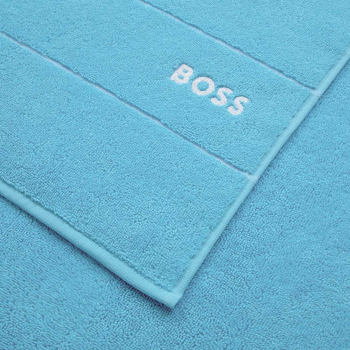 https://cdn.shopify.com/s/files/1/1268/4551/products/fig-linens-hugo-boss-plain-river-blue-bath-towels-closeup_1600x.jpg?v=1645721213