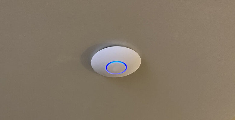 wireless access point being used on a wall
