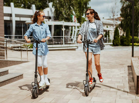 Mom-daughter-scooters-city