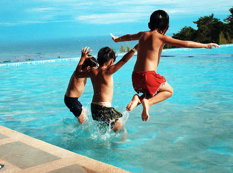 boys-jumping-in-pool-summer